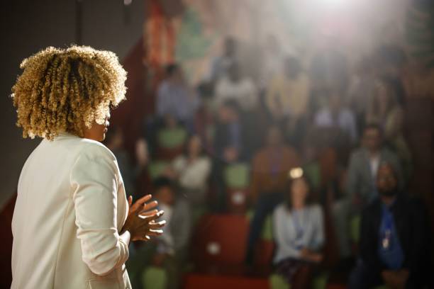 rear view of the public speaker giving talk at conference event.